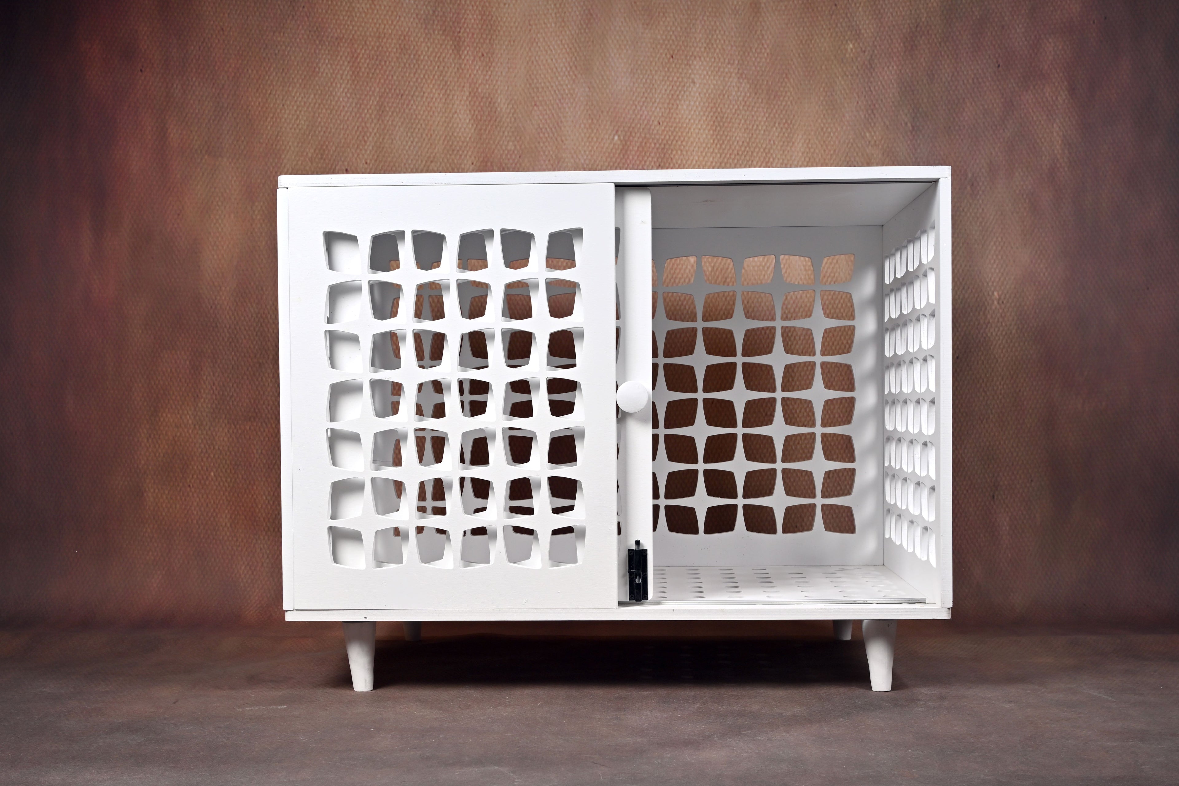 White dog crate with grid pattern doors on a brown background