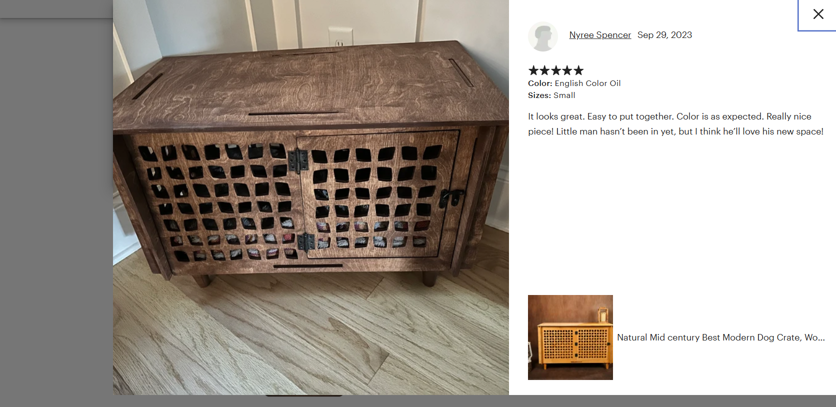 Wooden pet crate with lattice design on a wooden floor