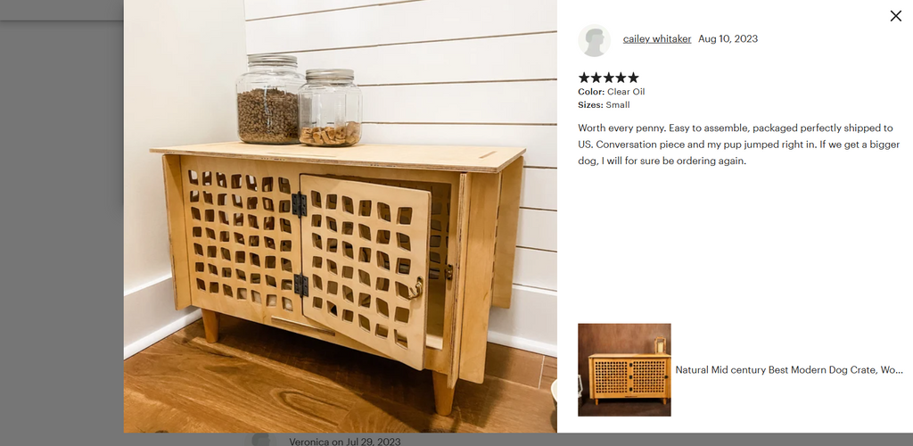 Wooden pet crate with lattice design on a wooden floor against a white wall.